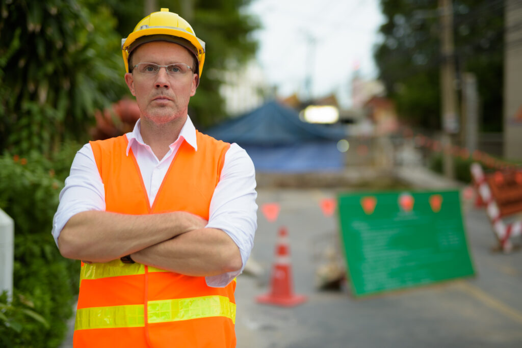 Mature man construction worker at the construction site in the c